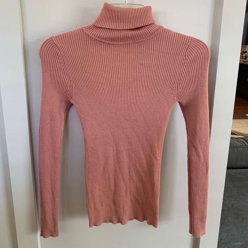 Women’s tight fitting pink turtleneck sweater top
